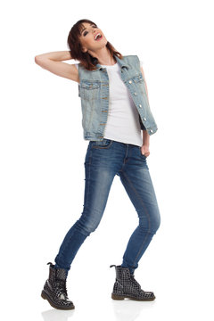 Young Rock Girl Is Standing Legs Apart, Looking Away And Shouting