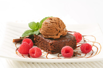 Brownie with ice cream and raspberries