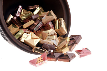 bowl with caramel candy isolated on white background
