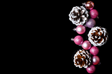 Christmas background: balls and bumps on a black background, free space.