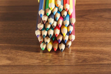 Set of colored pencils, wooden background