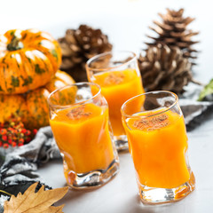 Thanksgiving autumn alcohol drink cocktail beverage with pumpkins and leaves
