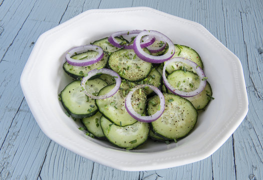 Cucumber salad with red onion and ground pepper.