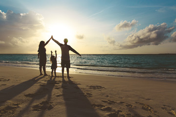Fototapeta premium happy family with kids play at sunset beach