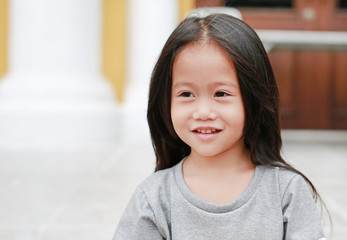 Smiling asian child girl outdoor. Portrait beautiful girl looking something.