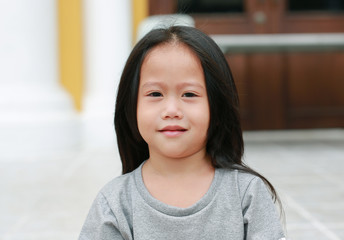 Smiling asian child girl outdoor. Portrait beautiful girl looking at camera.