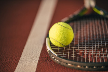 Balls and racket on tennis court