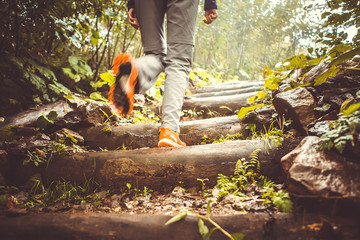 Image of man walking on ladder from logs