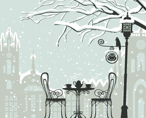 Vector winter cityscape with snow-covered branches of tree and open-air cafe with lamppost and crow on the background of old european town