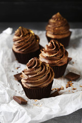 Tasty cupcakes with pieces of chocolate