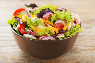 Vegetable salad in bowl on grey wooden table