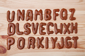 Chocolate cookies alphabet on brown wooden table