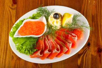Sliced trout and red caviar