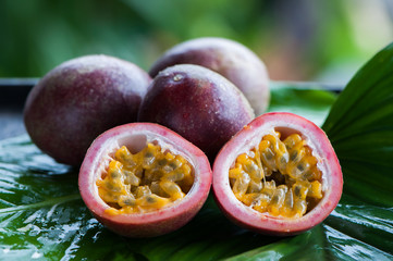 Passion fruit whole and slise on a natural background. Tropical fruits. The Fruit of Passion....