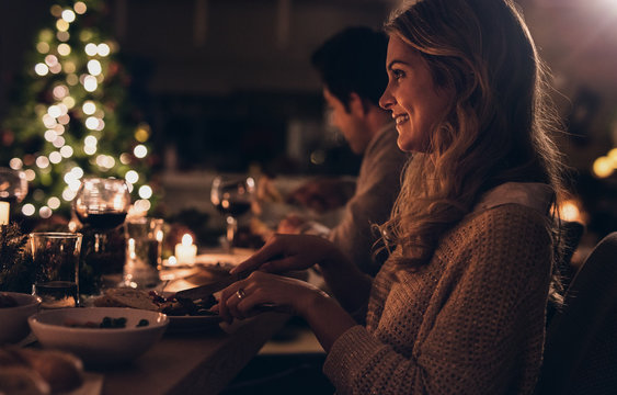 Beautiful woman having christmas dinner with family