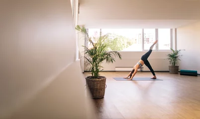 Zelfklevend Fotobehang Fitness woman practising yoga indoors © Jacob Lund