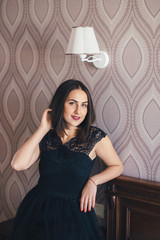 Young pretty girl posing in a beautiful room with wooden furniture