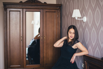 Young pretty girl posing in a beautiful room with wooden furniture