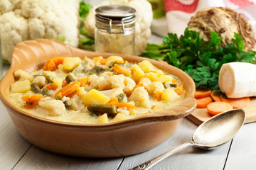Vegetable soup with ingredients carrot, cauliflower, potato and