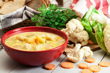 Vegetable soup with ingredients carrot, cauliflower, potato and parsley