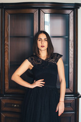 Fototapeta premium Young pretty girl posing in a beautiful room with wooden furniture
