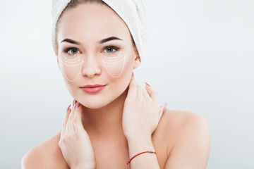 Pretty girl with naked shoulders and white towel on hair