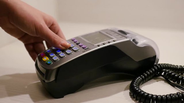 Holds a card through the bank terminal. HD, 1920x1080, slow motion.