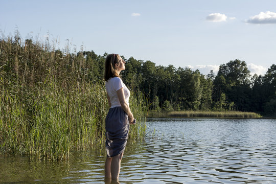 Young woman enjoying the sun at a lake