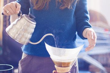 Barista girl brewing coffee
