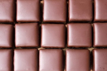 Chocolate in the shape of a cube, close-up, background