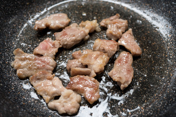 Close up cooking fried pork on pan
