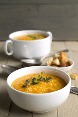 Vegetarian pumpkin soup on a wooden table.