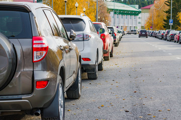 Naklejka premium Urban street landscape. Different cars are on the side of the roadway