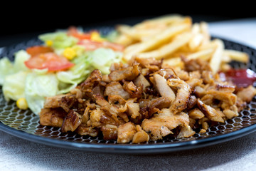 Fresh chicken steak with tomatoes and french fries