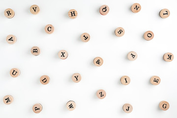 Background from the letters of the English alphabet on wooden cylinders. Stamps. Background for your text and design

