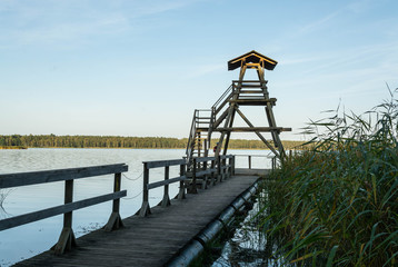 Fototapeta na wymiar Wooden tower to watch birds on Sloka lake at sunset. Kemeri national park, Latvia.