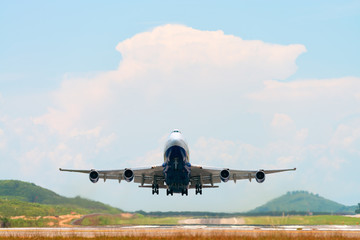 Fototapeta na wymiar Airplane take off above airport runway