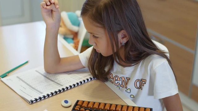 A girl of 8 years of age studies at home on mental arithmetic