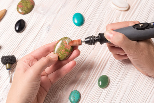 Jeweler working with jewelry tools and gemstones