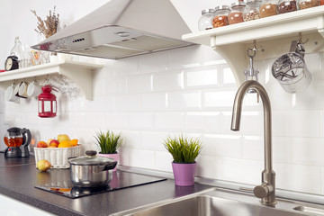 Interior of a light kitchen in the apartment. Bright home interior decoration items, fruit, flowers...