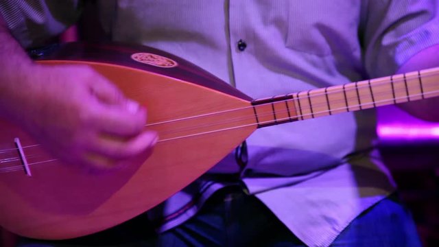 Turkish man playing saz
