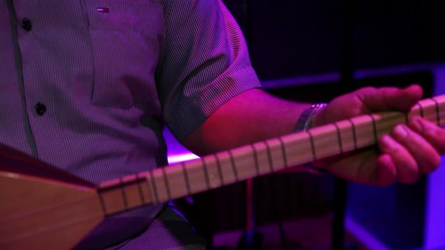 Turkish man playing saz turkish guitar