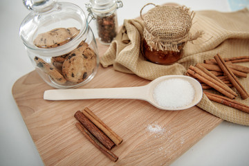 Sweet honey with cinnamon and cookie on desk