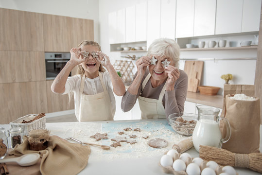 Glad Grandmother And Child Enjoying Baking Process