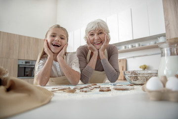Happy girl likes to cook with her granny