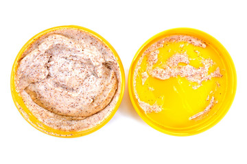 Closeup open cosmetic cream bottle with lid isolated on white background