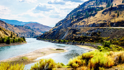 The Trans Canada Highway winding through the mountains and along the Thompson River between the towns of Cache Creek and Spences Bridge in central British Columbia © hpbfotos