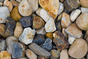 Multicolored stones on the sea coast close-up
