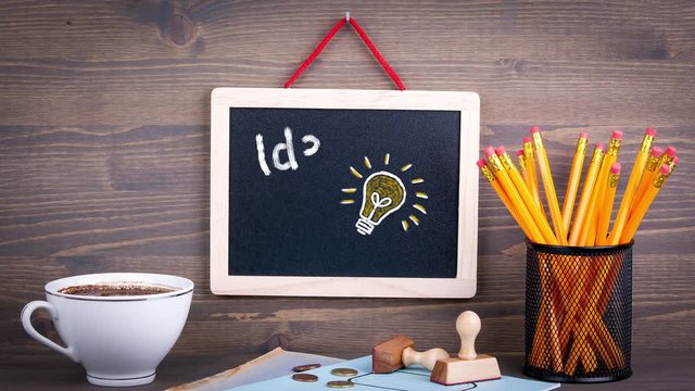 Idea. Chalkboard on a wooden desk. Business and success background.