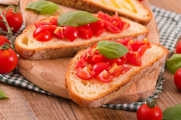 Bruschetta bread with basil and chopped tomatoes. 